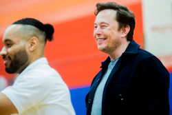 Tech billionaire Elon Musk smiles while he and other Tesla officials talk with hundreds of students on Friday, March 22, 2019, at Doyle-Ryder Elementary School in Flint, Mich.
