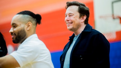Tech billionaire Elon Musk smiles while he and other Tesla officials talk with hundreds of students on Friday, March 22, 2019, at Doyle-Ryder Elementary School in Flint, Mich.