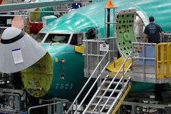 A worker enters a Boeing 737 MAX 8 airplane during a brief media tour of Boeing's 737 assembly facility, Wednesday, March 27, 2019, in Renton, Wash.