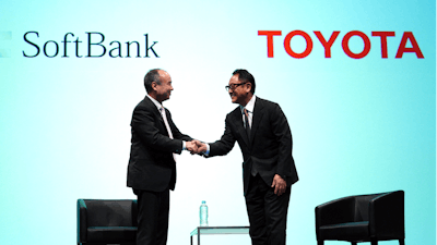 In this Oct. 4, 2018, file photo, Softbank Group Corp. Chairman Masayoshi Son, left, and Toyota Motor Corp. President Akio Toyoda shake hands after a press conference in Tokyo.