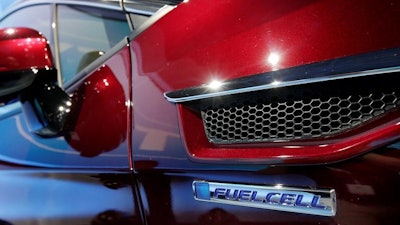 The fuel cell logo adorns the fender of a Honda Clarity at a media preview at the New York International Auto Show on Wednesday, April 12, 2017.