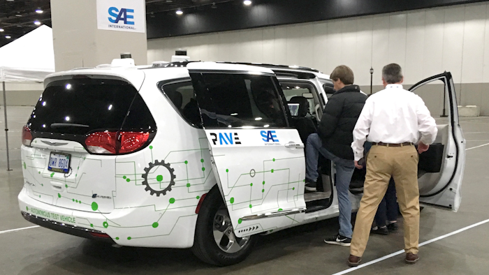 A person gets into a self-driving Chrysler Pacifica Hybrid Friday, April 5, 2019, in Detroit.