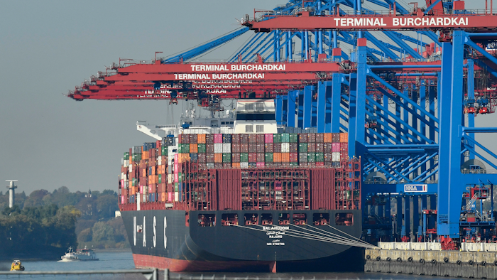 In this Monday, Oct. 15, 2018, file photo, a container ship is loaded at the harbor in Hamburg, Germany.