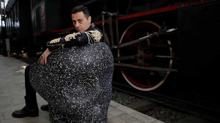 In this picture taken on Saturday, April 13, 2019, Italian designer Fabio Novembre poses on his 'Jolly Roger' chair at the National Museum of Science and Technology in Milan.