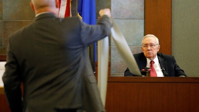 Former U.S. Sen. Harry Reid sits in the witness stand, Thursday, March 28, 2019, in Las Vegas.