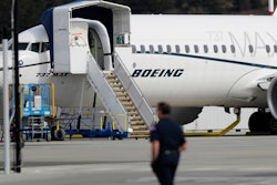 In this March 14, 2019, file photo, a worker walks next to a Boeing 737 MAX 8 airplane parked at Boeing Field in Seattle.