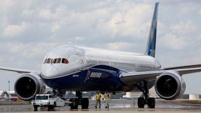 In this March 31, 2017, file photo, Boeing employees walk the new 787-10 Dreamliner down towards the delivery ramp area at the company's facility in South Carolina.