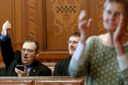 Val Finnell, left, gives a thumbs down as others applaud after the Pittsburgh City Council voted 6-3 to pass gun-control legislation, Tuesday, April 2, 2019.
