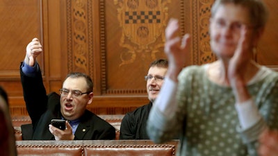 Val Finnell, left, gives a thumbs down as others applaud after the Pittsburgh City Council voted 6-3 to pass gun-control legislation, Tuesday, April 2, 2019.