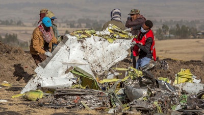 In this March 11, 2019, file photo, rescuers work at the scene of an Ethiopian Airlines flight crash near Bishoftu, Ethiopia.
