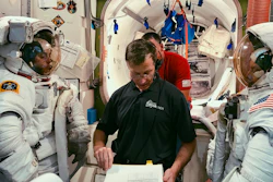 In this February 2019 photo, Boeing astronaut Chris Ferguson helps NASA astronauts Nicole Mann, left, and Mike Fincke, right, train for a spacewalk inside the International Space Station Airlock Mockup at NASA's Johnson Space Center in Houston.