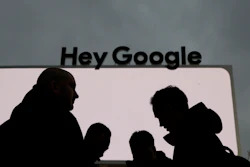In this Jan. 5, 2019, file photo, people stand in front of the Google tent during preparations for CES International in Las Vegas.