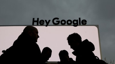 In this Jan. 5, 2019, file photo, people stand in front of the Google tent during preparations for CES International in Las Vegas.