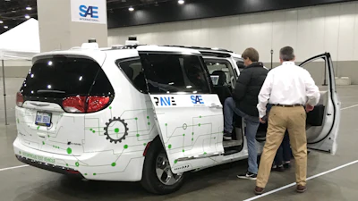 A person gets into a self-driving Chrysler Pacifica Hybrid Friday, April 5, 2019, in Detroit.