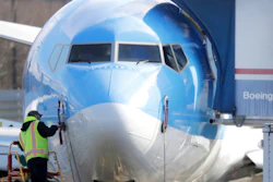 In this March 13, 2019, file photo, a worker stands on a platform near a Boeing 737 MAX 8 airplane at Boeing Co.'s Renton Assembly Plant in Renton, Wash.