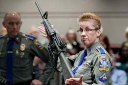 In this Jan. 28, 2013, file photo, firearms training unit Detective Barbara J. Mattson, of the Connecticut State Police, holds a Bushmaster AR-15 rifle.