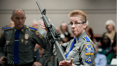 In this Jan. 28, 2013, file photo, firearms training unit Detective Barbara J. Mattson, of the Connecticut State Police, holds a Bushmaster AR-15 rifle.