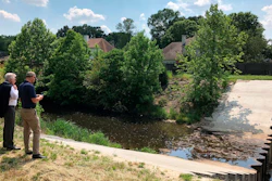 In this May 15, 2018, file photo, two men inspect a U.S. Army Corps of Engineers project to prevent erosion in an important storm sewage channel in Germantown, Tenn.