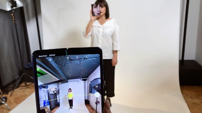 In this April 16, 2019, file photo, a model holds a Samsung Galaxy Fold smart phone to her face during a media preview event in London.