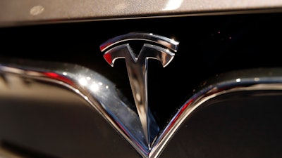 This Oct. 3, 2018, file photo shows a Tesla emblem at the Auto show in Paris.