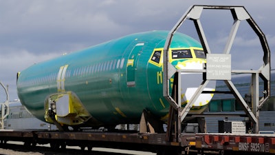 In this April 9, 2019, file photo, a Boeing 737 fuselage sits on a flatcar rail car at a rail yard in Seattle.
