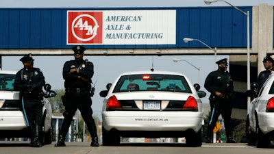 In this April 24, 2008, file photo, Detroit police officers block an entrance to the American Axle and Manufacturing Holdings plant in Detroit.