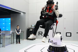 In this April 2, 2019, photo, a visitor rides a virtual roller coaster ride operated by a robotic arm in a VR theme park in Nanchang, China.
