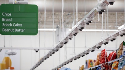 Dozens of cameras hang above an aisle at a Walmart Neighborhood Market, Wednesday, April 24, 2019, in Levittown, N.Y.