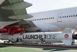 In this Thursday, Oct. 25, 2018, photo, a LauncherOne rocket hangs from the wing of Cosmic Girl, a special Boeing 747 aircraft that is used as the rocket's 'flying launch pad.'