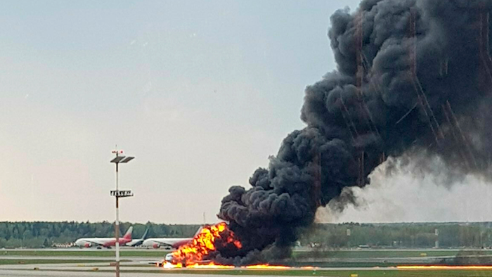 This image, provided by Riccardo Dalla Francesca, shows smoke rising from a fire on a plane at Moscow's Sheremetyevo airport on Sunday, May 5, 2019.