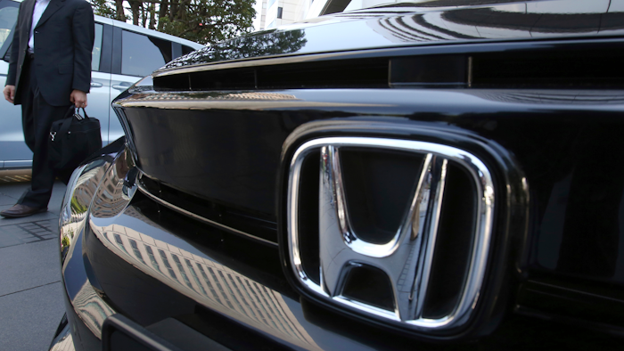 A visitor looks at a car displayed at the showroom at the Honda Motor Co. headquarters in Tokyo, Wednesday, May 8, 2019.