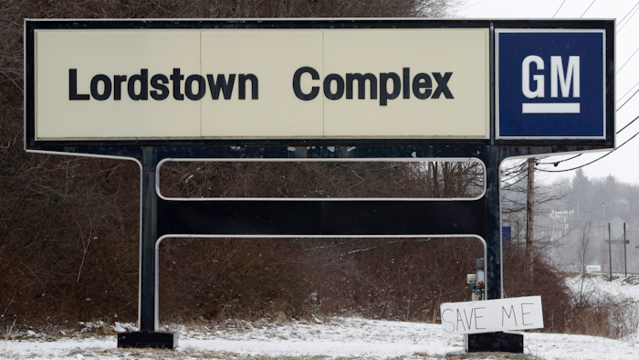 In this March 6, 2019, file photo, a 'Save Me' sign rests against the General Motors Lordstown Complex sign in Lordstown, Ohio.