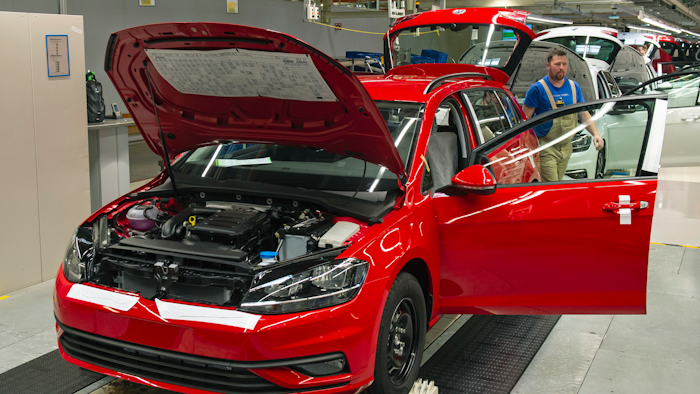 In this Tuesday, May 14, 2019, photo, workers complete Golf car bodies at the assembly line during a press tour of the Volkswagen plant in Zwickau, Germany.