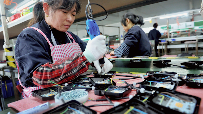 In this Saturday, March 30, 2019, file photo, workers assemble LED lights at a factory in Yushan county in central China's Jiangxi province.