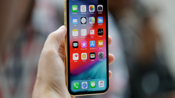 This Sept. 12, 2018, file photo shows an Apple iPhone XR on display at the Steve Jobs Theater in Cupertino, Calif.