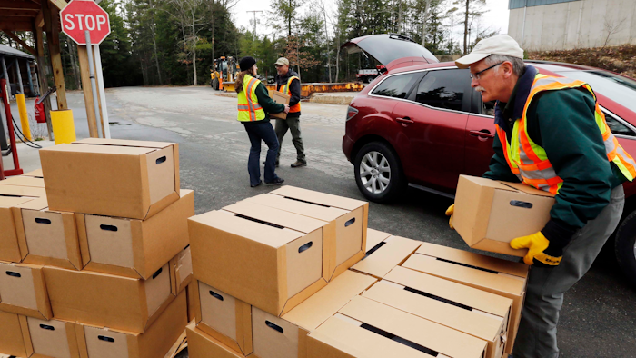 In this Monday, April 11, 2016, file photo, officials load boxes of bottled water in in Litchfield, N.H.