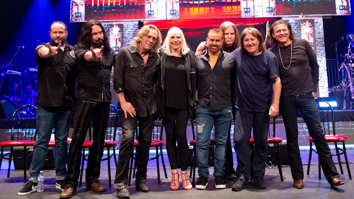 This May 23, 2019, photo shows, from left, singer Tim Owens, bassist Bjorn Englen, keyboardist Scott Warren, Wendy Dio, widow of Ronnie James Dio, Eyellusion CEO Jeff Pezzutti, guitarist Craig Goldy, drummer Simon Wright and singer Oni Logan.