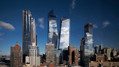 In this Dec. 4, 2018 photo, skyscrapers rise above Hudson Yards on the west side of Manhattan.