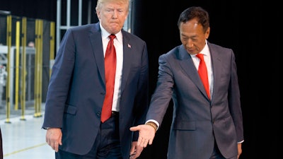 In this Thursday, June 28, 2018, file photo, President Donald Trump takes a tour of Foxconn with Foxconn chairman Terry Gou in Mt. Pleasant, Wis.