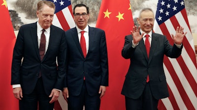 In this file photo taken Wednesday, May 1, 2019, Chinese Vice Premier Liu He, right, gestures as U.S. Treasury Secretary Steven Mnuchin chats with his Trade Representative Robert Lighthizer before a meeting in Beijing.