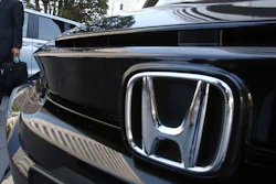 A visitor looks at a car displayed at the showroom at the Honda Motor Co. headquarters in Tokyo, Wednesday, May 8, 2019.