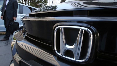 A visitor looks at a car displayed at the showroom at the Honda Motor Co. headquarters in Tokyo, Wednesday, May 8, 2019.