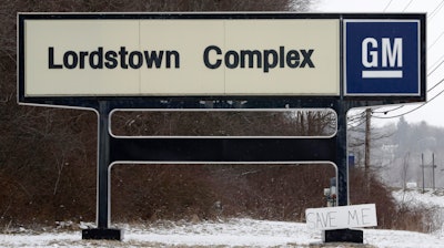 In this March 6, 2019, file photo, a 'Save Me' sign rests against the General Motors Lordstown Complex sign in Lordstown, Ohio.