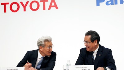 Toyota Motor Corp. operating officer Masayoshi Shirayanagi and Panasonic senior managing executive officer Makoto Kitano talk during a press conference in Tokyo, Thursday, May 9, 2019.