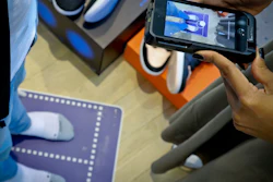 Nike officials demonstrate the company's foot-scanning tool on its app Wednesday April 24, 2019, in New York.