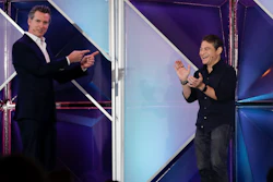 California Gov. Gavin Newsom, left, jokes with X Prize founder and chairman Peter Diamandis during the Near Future conference, Friday, May 10, 2019, in San Diego.