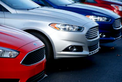 In this Nov. 19, 2015, photo, a row of new Ford Fusions are for sale on the lot at Butler County Ford in Butler, Pa.