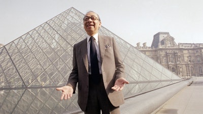 In this March 29, 1989, file photo, architect I.M. Pei laughs while posing for a portrait in front of the Louvre glass pyramid prior to its inauguration in Paris.