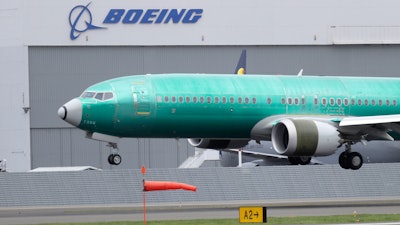 In this April 10, 2019, file photo, a Boeing 737 Max 8 airplane lands following a test flight at Boeing Field in Seattle.