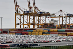 Cars for export and import are stored in front of containers on Thursday, May 16, 2019, at the harbor in Bremerhaven, Germany.